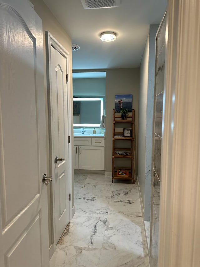 bathroom featuring marble finish floor, visible vents, and vanity