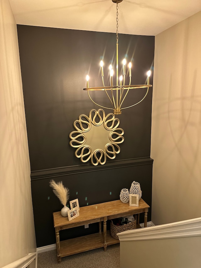 details featuring baseboards, carpet, and an inviting chandelier