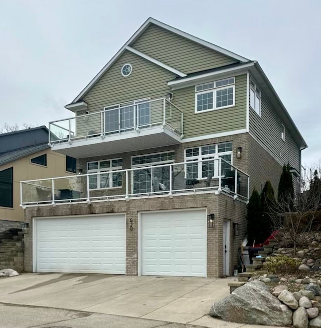 view of front of house with a garage, driveway, and brick siding