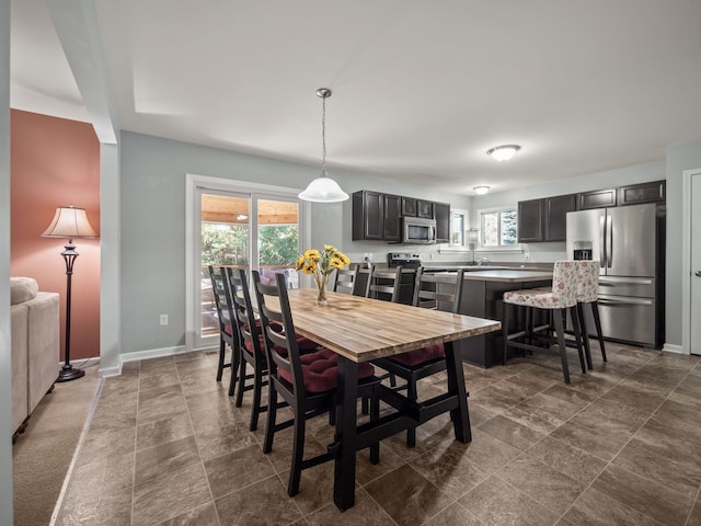 dining space featuring baseboards