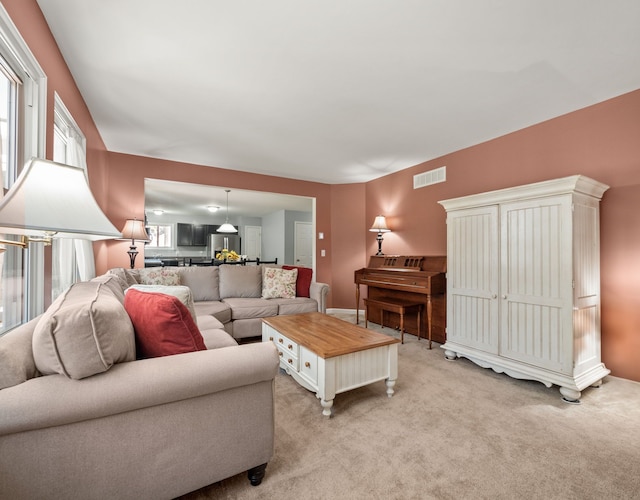 living room with light colored carpet and visible vents