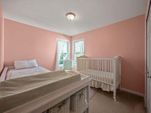 bedroom featuring carpet flooring and baseboards