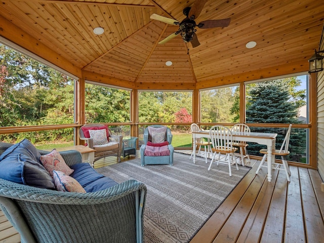 sunroom featuring a ceiling fan, lofted ceiling, and wood ceiling