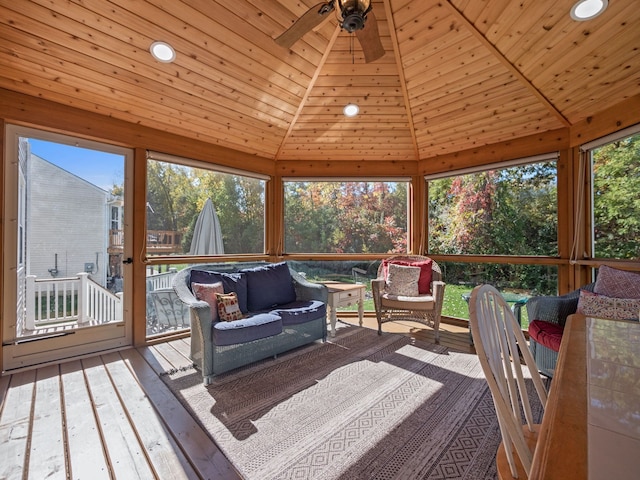 sunroom with lofted ceiling, wood ceiling, and a ceiling fan