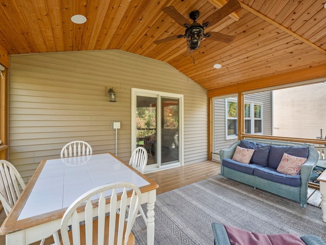 sunroom with lofted ceiling, ceiling fan, wooden ceiling, and plenty of natural light