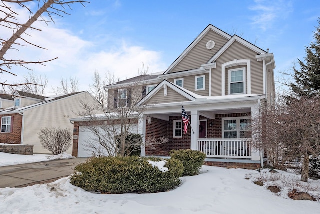 view of front of house featuring a garage, covered porch, driveway, and brick siding