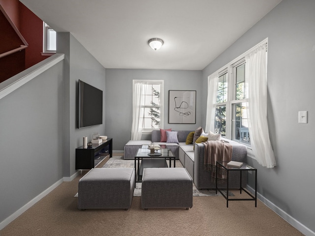 living area featuring carpet flooring and baseboards