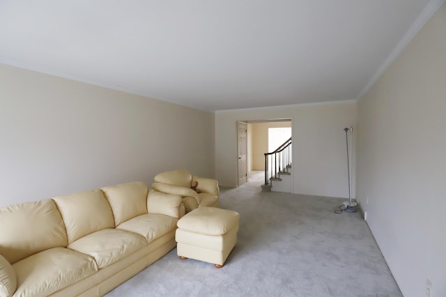 living room with stairs, ornamental molding, and light carpet