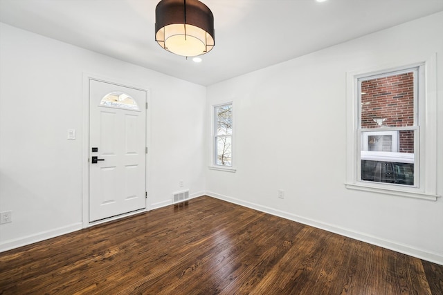 interior space with dark wood-style floors, baseboards, visible vents, and recessed lighting