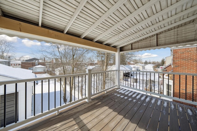 snow covered deck featuring a residential view