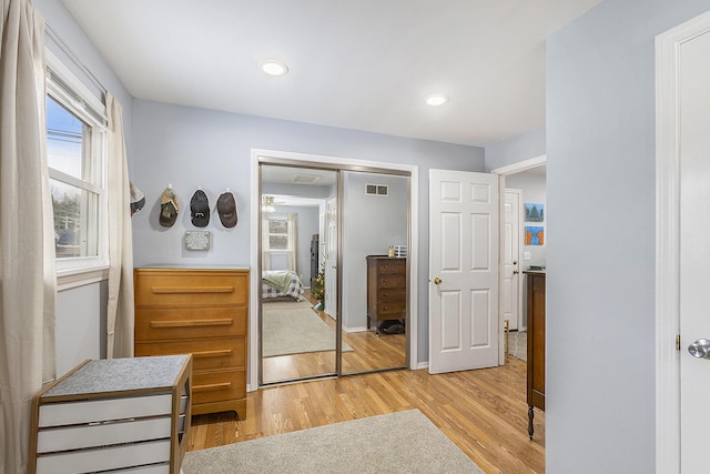 interior space with light wood-style flooring, visible vents, baseboards, and recessed lighting