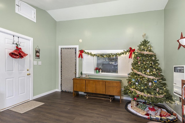 foyer with vaulted ceiling, baseboards, and wood finished floors