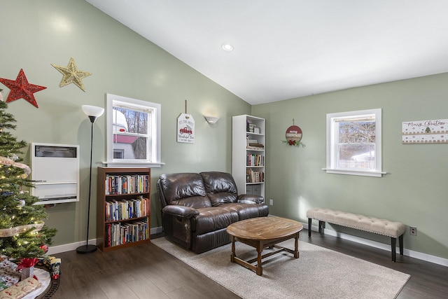 living area with baseboards, lofted ceiling, dark wood-style floors, heating unit, and recessed lighting