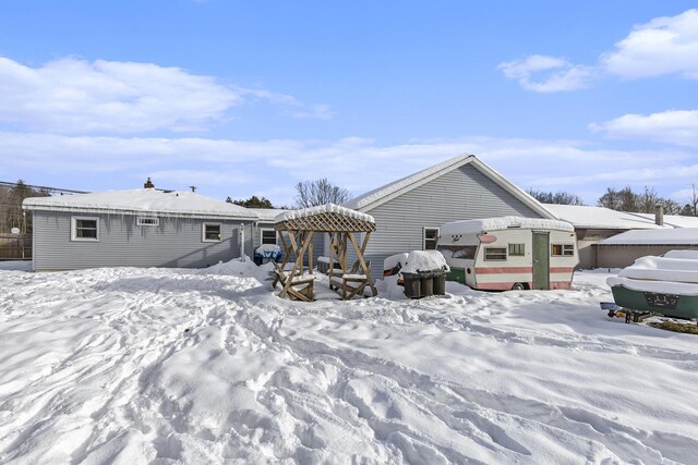 view of snow covered rear of property