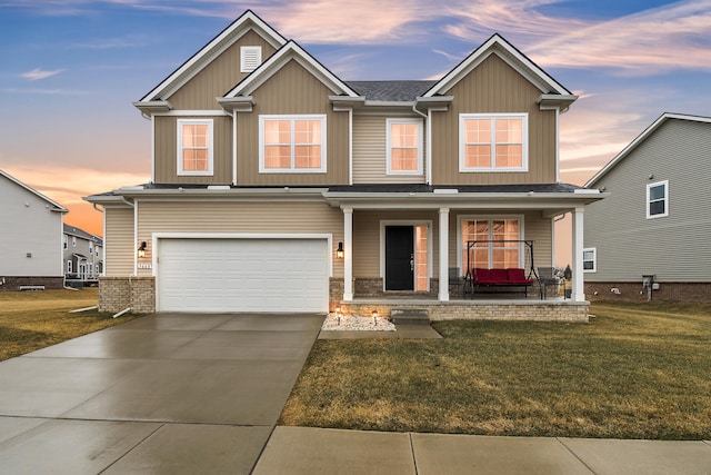 craftsman-style home featuring an attached garage, driveway, a porch, and a lawn