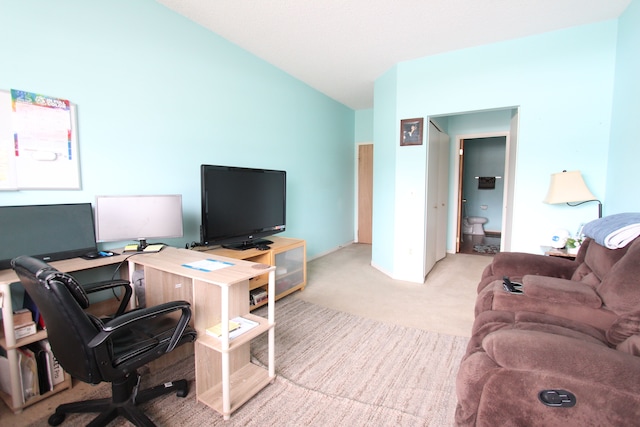 office space featuring carpet and vaulted ceiling