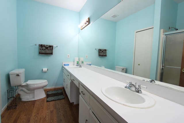 full bath with a sink, toilet, and wood finished floors