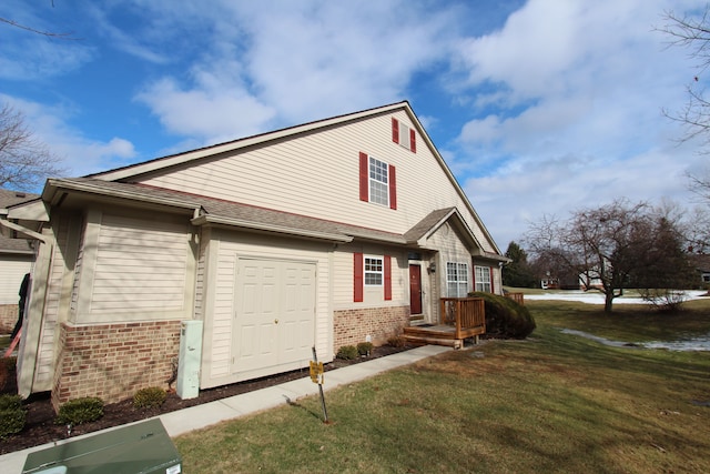 view of property exterior with roof with shingles, a lawn, and brick siding