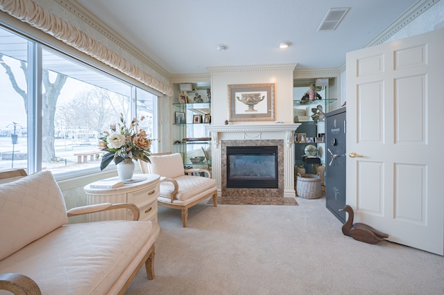 living room with carpet floors, ornamental molding, a premium fireplace, and visible vents