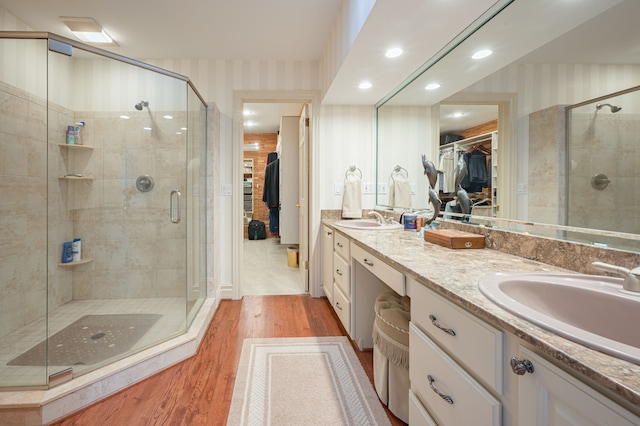 bathroom with a stall shower and a sink