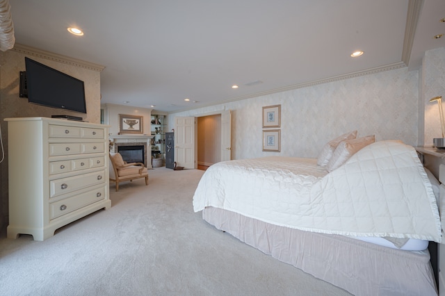 bedroom with recessed lighting, ornamental molding, a glass covered fireplace, light carpet, and wallpapered walls