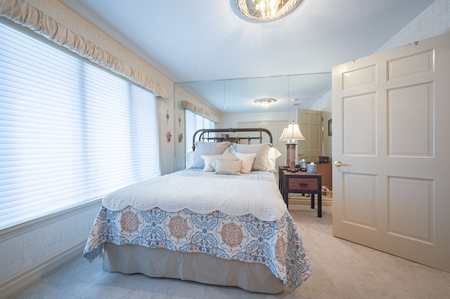 bedroom with vaulted ceiling, carpet flooring, and wallpapered walls