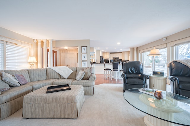 living room with ornate columns, light wood-style flooring, and recessed lighting