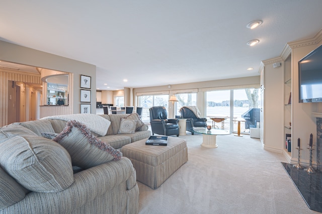 living room with recessed lighting, light carpet, and baseboards