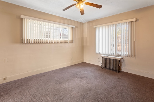 spare room with baseboards, radiator heating unit, a ceiling fan, and carpet floors