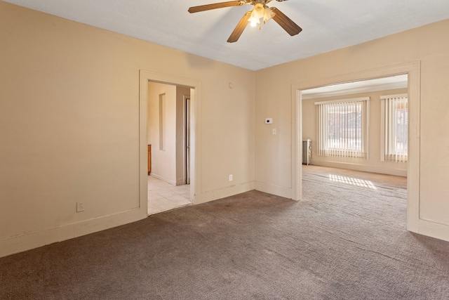 empty room with light carpet and ceiling fan