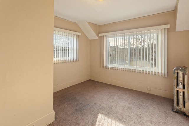 carpeted spare room featuring baseboards