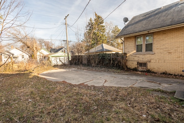 view of yard featuring fence and a patio area