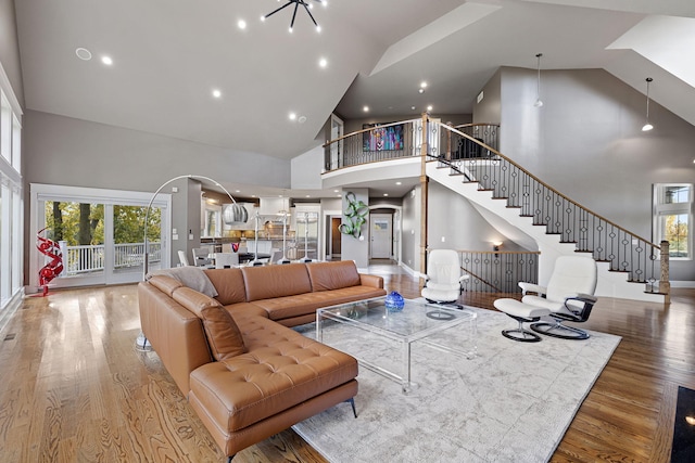 565 Golden Bear Ct, Saint Joseph, MI 49085 - living room with high vaulted ceiling, plenty of natural light, stairway, and wood finished floors