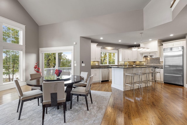 565 Golden Bear Ct, Saint Joseph, MI 49085 - dining space with high vaulted ceiling, light wood-style flooring, and recessed lighting