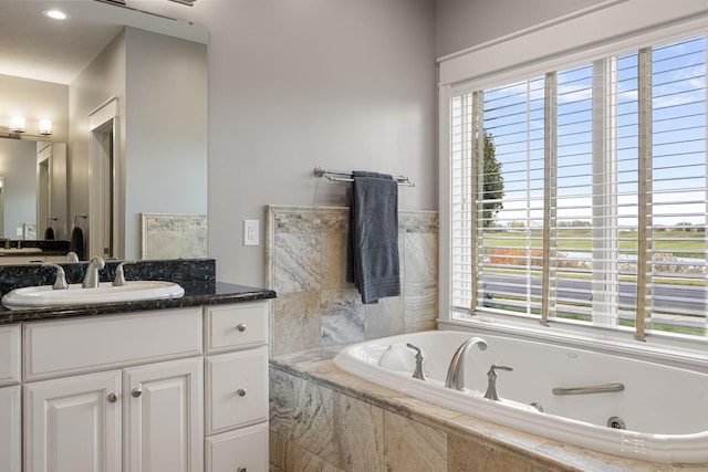 565 Golden Bear Ct, Saint Joseph, MI 49085 - bathroom featuring a jetted tub, a wealth of natural light, and vanity
