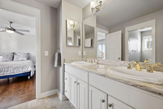 565 Golden Bear Ct, Saint Joseph, MI 49085 - full bath with ceiling fan, double vanity, a sink, and baseboards