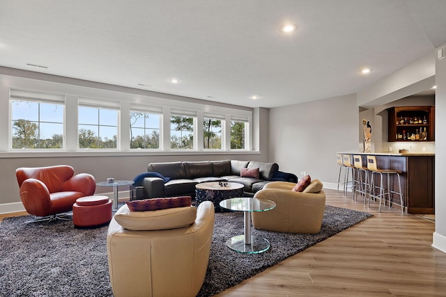 565 Golden Bear Ct, Saint Joseph, MI 49085 - living area featuring recessed lighting, wood finished floors, bar area, and baseboards
