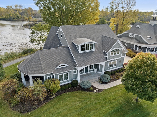 565 Golden Bear Ct, Saint Joseph, MI 49085 - exterior space featuring a water view, a shingled roof, and a lawn