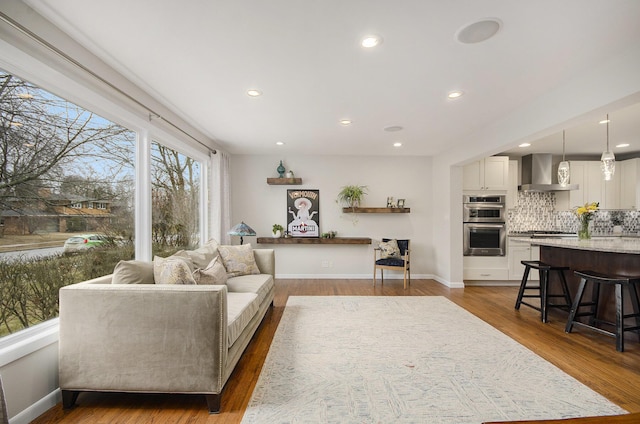 living room with baseboards, dark wood-style flooring, and recessed lighting