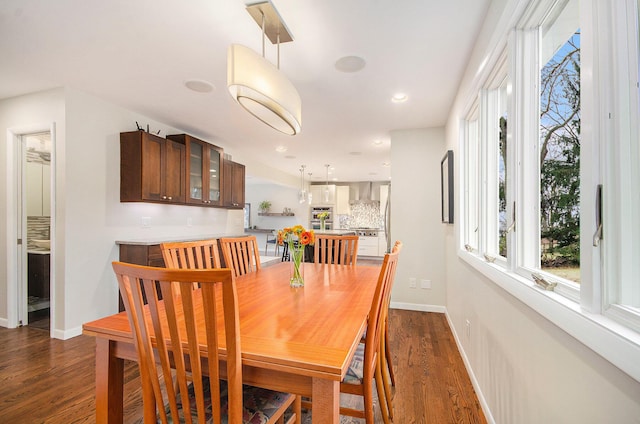 dining area featuring baseboards, dark wood-type flooring, and recessed lighting