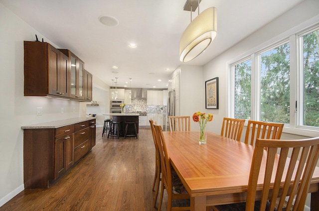 dining space with a healthy amount of sunlight, dark wood-style floors, baseboards, and recessed lighting