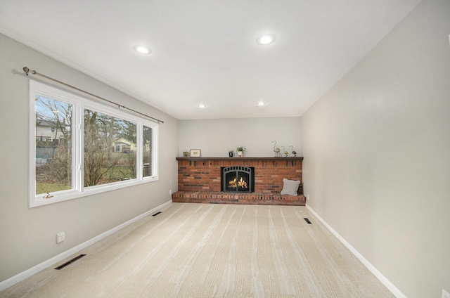 carpeted living room featuring recessed lighting, a brick fireplace, visible vents, and baseboards