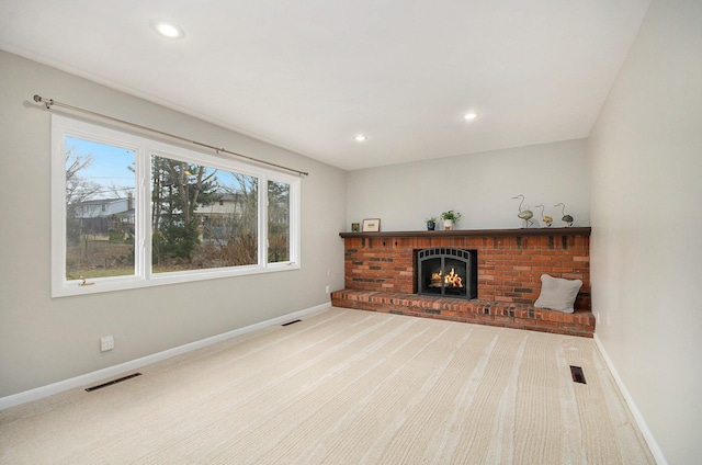 living area with baseboards, visible vents, and carpet flooring