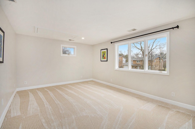 unfurnished room featuring light carpet, baseboards, visible vents, and recessed lighting