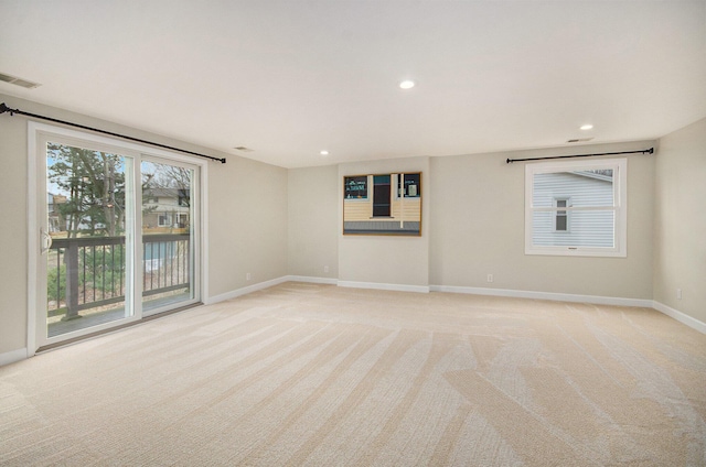 spare room featuring recessed lighting, light colored carpet, visible vents, and baseboards