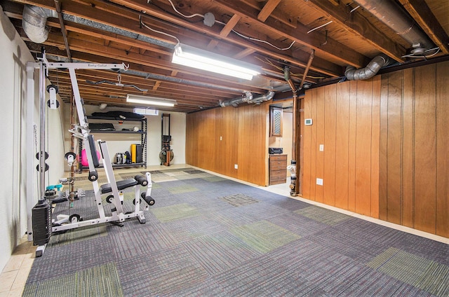 unfinished below grade area featuring carpet floors and wooden walls