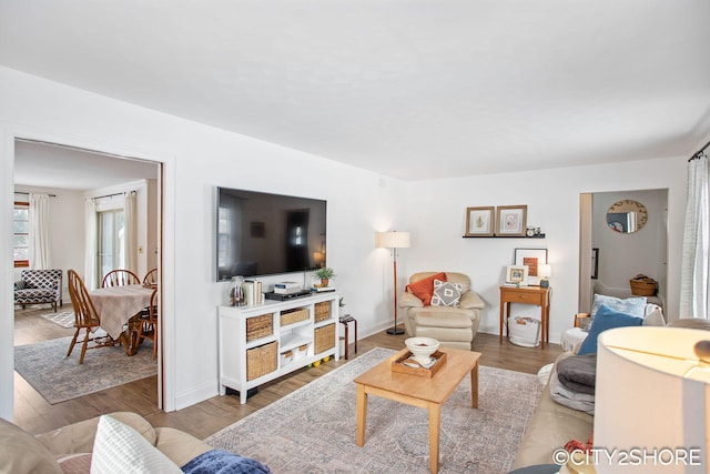 living room featuring baseboards and wood finished floors