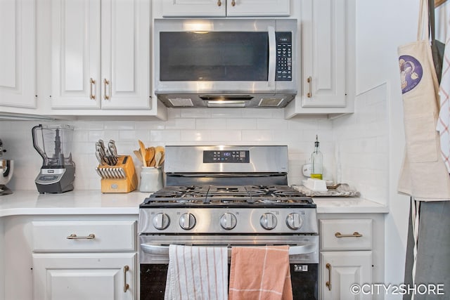 kitchen featuring stainless steel appliances, decorative backsplash, light countertops, and white cabinets