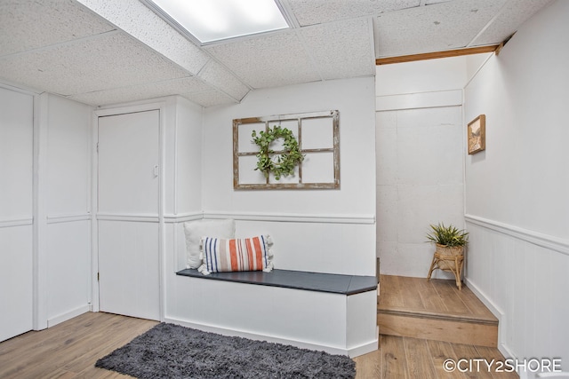 interior space featuring wood finished floors and a paneled ceiling