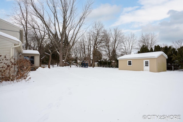 yard covered in snow with an outdoor structure